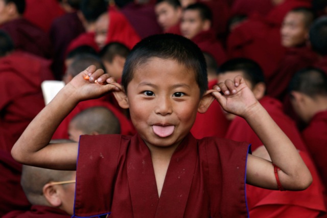 young-buddhist-monk-makes-face-during-dalai-lamas-prayer-session-at-the-mahabodhi-temple-in-bodh-gaya-india-saturday-rajesh-kumar-singh